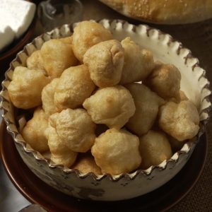 Montenegrin donuts can be served with traditional cheese and honey